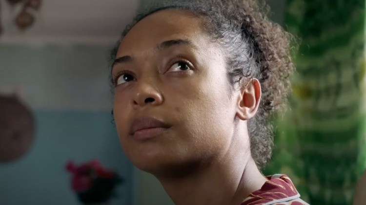 Shula, a character in On Becoming A Guinea Fowl, looks up with interest and suspicion towards the camera.